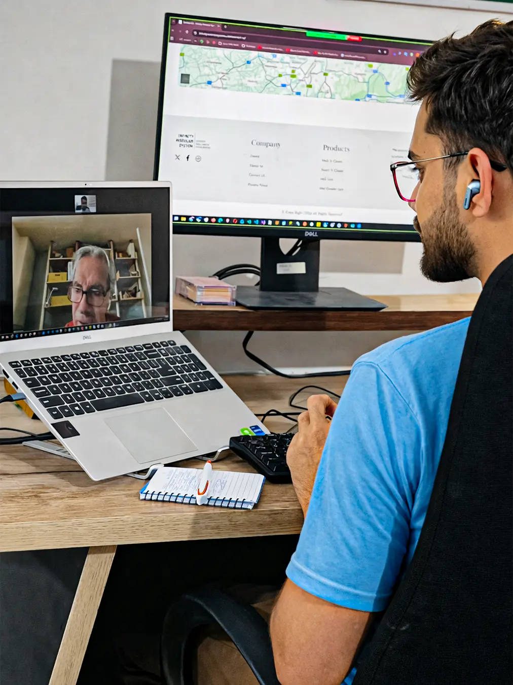 A high-focus work setup portrait featuring Abdul Basit RK seen from behind with a dual-monitor (laptop and vertical screen) setup, participating in a video call, part of a client consultation call